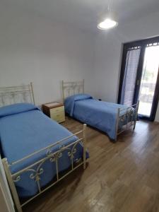 Posteľ alebo postele v izbe v ubytovaní La casa del sole (arcomagno San Nicola Arcella)