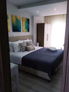 a bedroom with a large bed and a window at Myrto 's sea view in Kallithea Halkidikis
