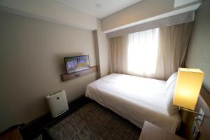 Postel nebo postele na pokoji v ubytování ibis Styles Tokyo Ginza
