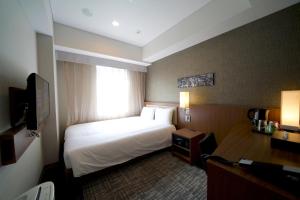 Postel nebo postele na pokoji v ubytování ibis Styles Tokyo Ginza
