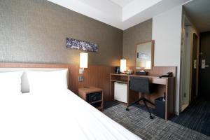 Postel nebo postele na pokoji v ubytování ibis Styles Tokyo Ginza