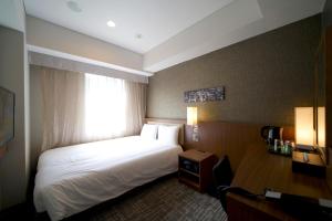 Postel nebo postele na pokoji v ubytování ibis Styles Tokyo Ginza