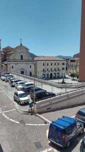 a parking lot with cars parked in front of a building at Piccolo paradiso in pieno centro Castel di Sangro in Castel di Sangro