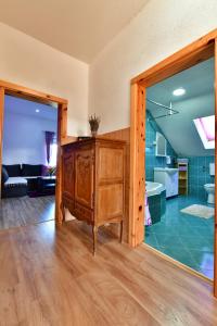 a room with a wooden cabinet and a bathroom at Lavanda farm apartmani in Rakovica