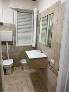 a bathroom with a sink and a toilet and a mirror at VISTAMARE VILLAGE in Silvi Marina
