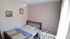 a bedroom with two beds with blue towels on them at Aristoteles Apartments in Olympiada