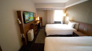 Postel nebo postele na pokoji v ubytování ibis Styles Tokyo Ginza