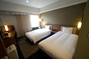 Postel nebo postele na pokoji v ubytování ibis Styles Tokyo Ginza