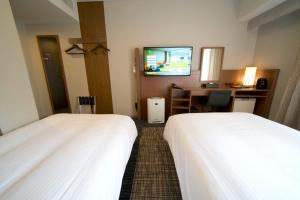Postel nebo postele na pokoji v ubytování ibis Styles Tokyo Ginza