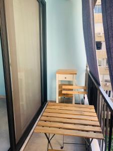 a wooden bench sitting on top of a balcony at Petrus Studio with balcony in Thessaloniki