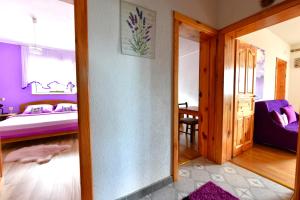 a room with a bed and a room with a mirror at Lavanda farm apartmani in Rakovica