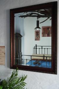 a mirror with a reflection of a bed in a room at Mascotas 1 in Benaocaz