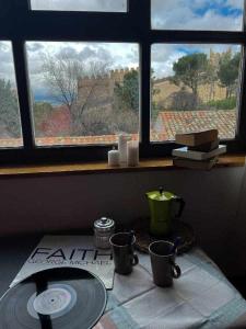 a table with a plate and a window with a view at Casa del Puente Muralla Homes in Ávila