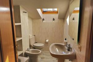 a small bathroom with a sink and a toilet at Casa del Puente MurallaHomes in Avila +41 photos