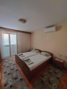 a small bedroom with a bed and a window at Rooms Diana in Dubrovnik