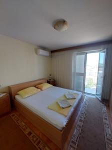 a bedroom with a large bed with a window at Rooms Diana in Dubrovnik
