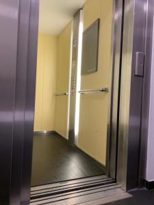 an elevator in an office building with a glass door at Room Available at City in Oslo