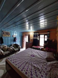 a bedroom with a large bed in a room at NotOnMap- Amaira Homestay in Khajjiar 