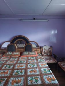 a bedroom with a bed with a quilt on it at NotOnMap- Amaira Homestay in Khajjiar 