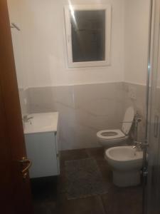 a bathroom with a toilet and a sink and a mirror at Oltre il Poggio del Sole in Marostica