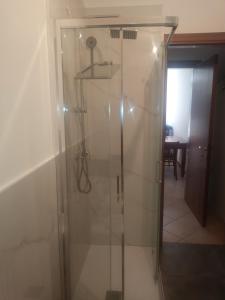 a shower with a glass door in a room at Oltre il Poggio del Sole in Marostica