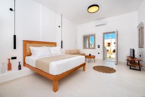 a bedroom with a bed and a living room at Centrio Fira Suites in Fira