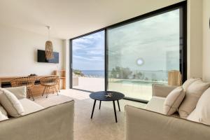 a living room with a view of the ocean at 'S CAVE VILLAS SEASIDE KARYSTOS in Karistos