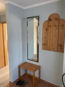 einen Spiegel und einen Tisch im Zimmer in der Unterkunft FeWo Lindenhof in Alt Reddevitz