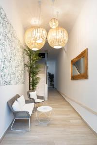un soggiorno con 2 sedie e un tavolo di Urban Suites Sitges Apartments a Sitges