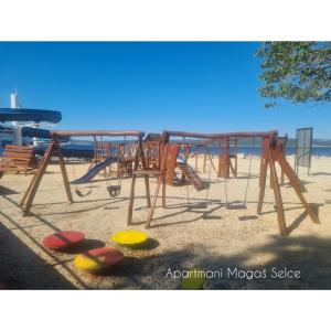 a group of picnic tables on the beach at Apartmani Magaš in Selce