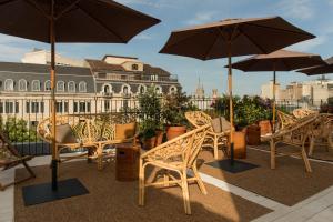 a group of chairs and umbrellas on a roof at Yurbban Ramblas Boutique Hotel in Barcelona