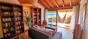 a living room with a couch and book shelves with books at CASA BALIMAR in Tarajalejo