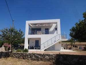 a white house with a staircase in front of it at Theros house in Kythira