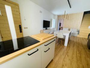a kitchen with a table and a dining room at Sdraiati Pollica - Apartments - Bed & Breakfast in Pollica