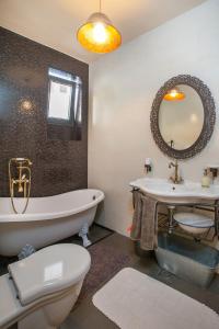a bathroom with a tub and a toilet and a sink at Apartments Glusac in Podgora