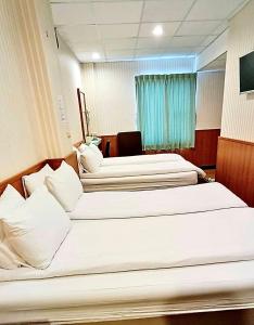 Katil atau katil-katil dalam bilik di Ying Lun Hotel