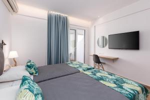 A bed or beds in a room at Sirocco Hotel