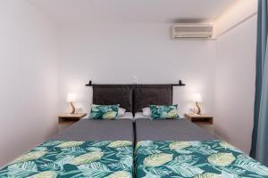 A bed or beds in a room at Sirocco Hotel