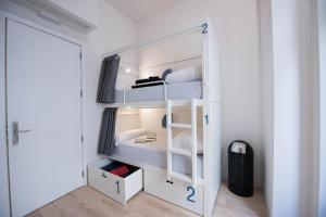 a small room with two bunk beds in it at Bluesock Hostels Madrid in Madrid