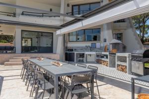 a patio with a table and chairs and a grill at SA GUARDA in Llafranc