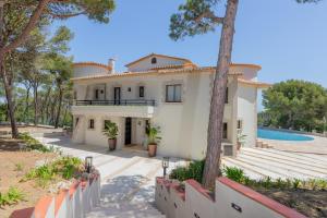 an exterior view of a house with a swimming pool at SA GUARDA in Llafranc