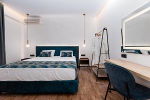 A bed or beds in a room at Sirocco Hotel