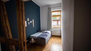 a small bedroom with a bed and a window at tRAUMhaus in Erfurt