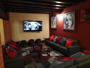 a living room with couches and a flat screen tv at Villa Burión in Llanera
