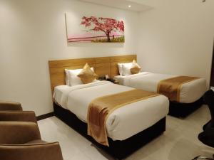 Postel nebo postele na pokoji v ubytování Hotel X Rajshahi