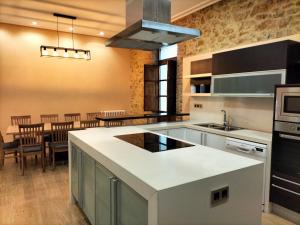 a kitchen with a large island in the middle of it at Villa Burión in Llanera