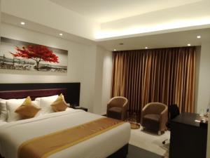 Postel nebo postele na pokoji v ubytování Hotel X Rajshahi
