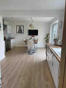 a kitchen and dining room with a table in it at Modern 4 bedroom house in Weymouth Sunny Corner in Weymouth
