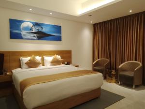 Postel nebo postele na pokoji v ubytování Hotel X Rajshahi