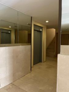 a hallway with glass doors and stairs in a building at El Ático reformado con aire acondicionado en el centro, ascensor, garaje y WiFi in Biescas